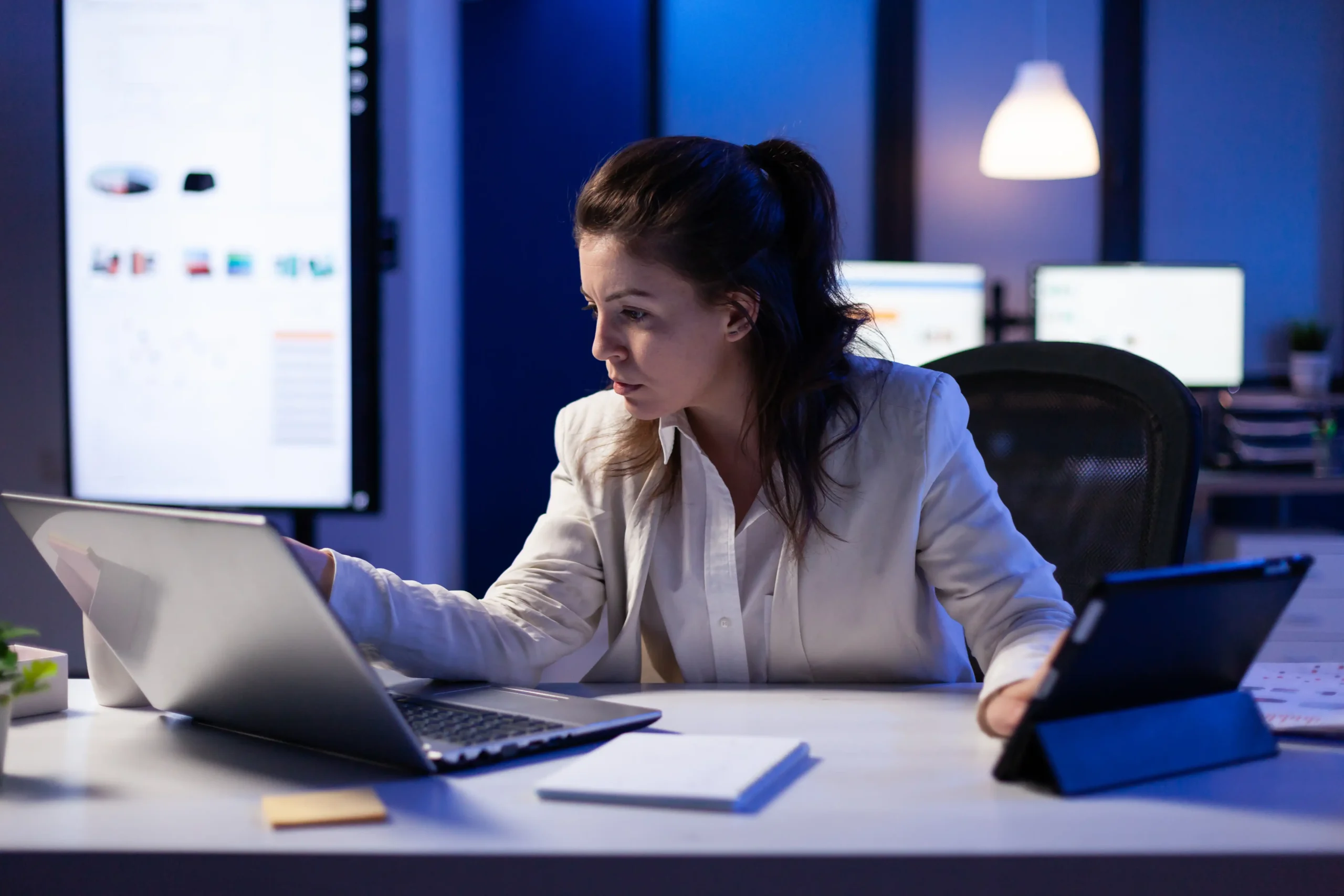 manager woman using laptop tablet same time working financial reports