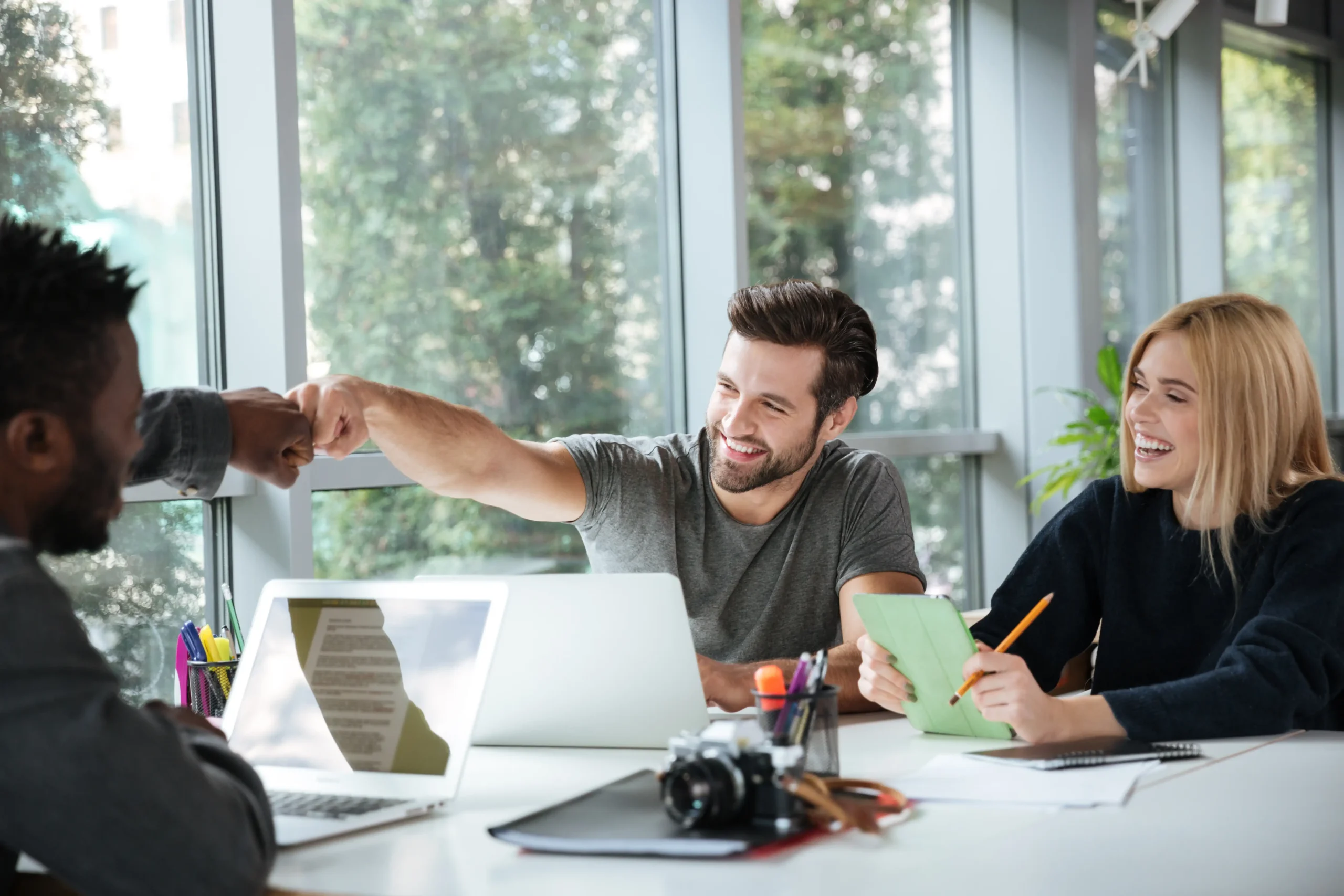 smiling young colleagues sitting office coworking